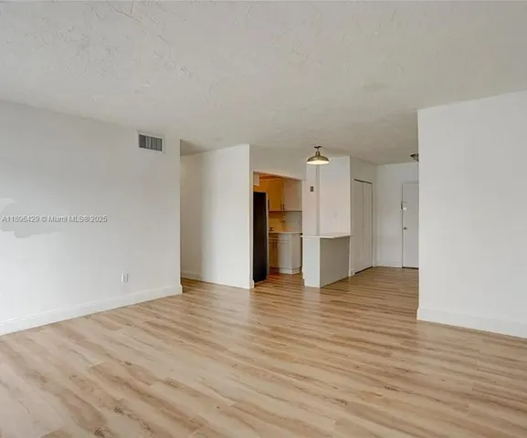 a kitchen with a sink cabinets and appliances