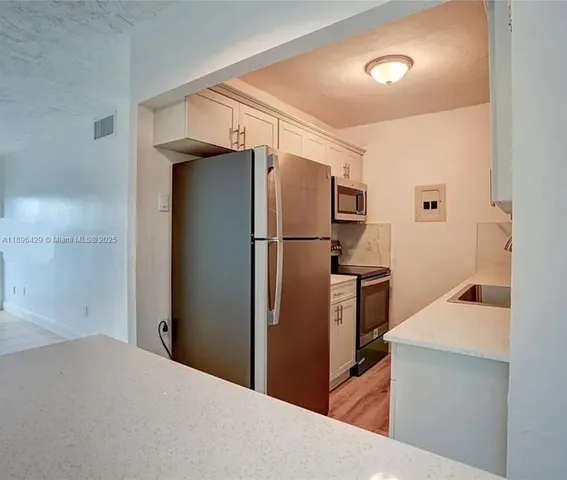 a view of a room with wooden floor