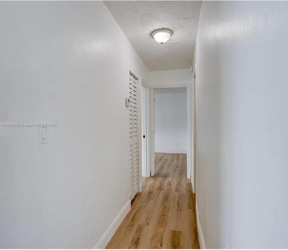 5501 Northwest 7th Street, Unit E408 Miami, FL 33126 - Photo 16 of 27 a view of a room with wooden floor