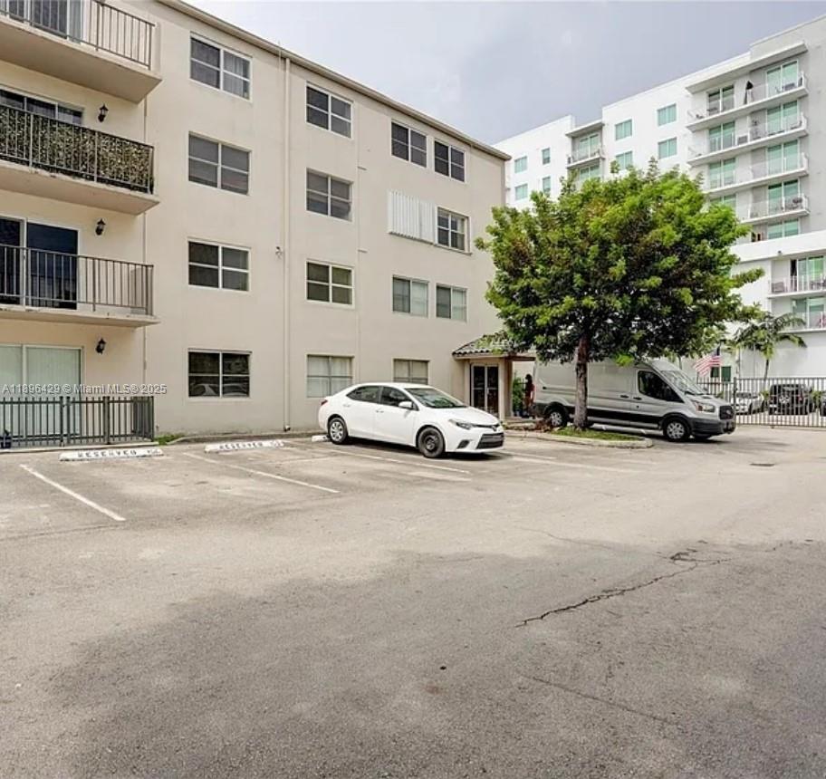 5501 Northwest 7th Street, Unit E408 Miami, FL 33126 - Photo 2 of 27 a car parked in front of a building