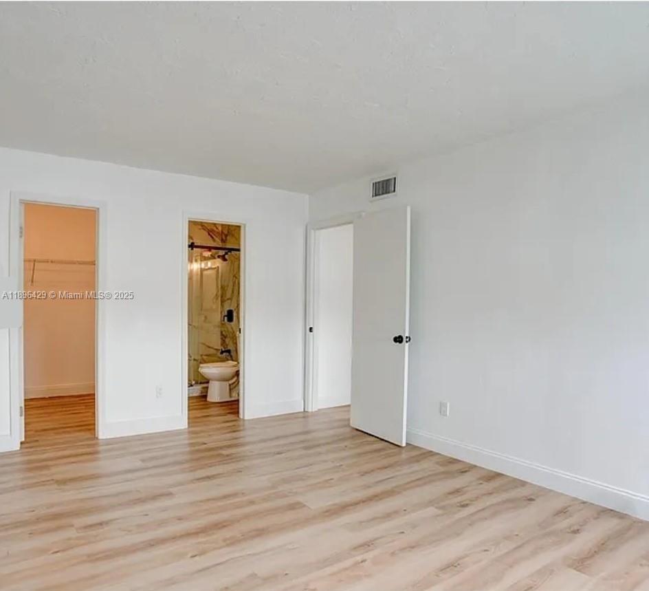 5501 Northwest 7th Street, Unit E408 Miami, FL 33126 - Photo 21 of 27 a view of an empty room and wooden floor