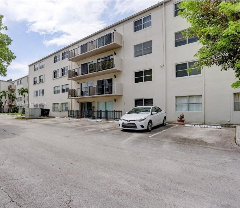 5501 Northwest 7th Street, Unit E408 Miami, FL 33126 - Photo 3 of 27 a car parked in front of a building