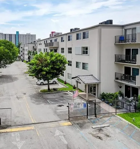 a view of a patio with a table and chairs under an umbrella