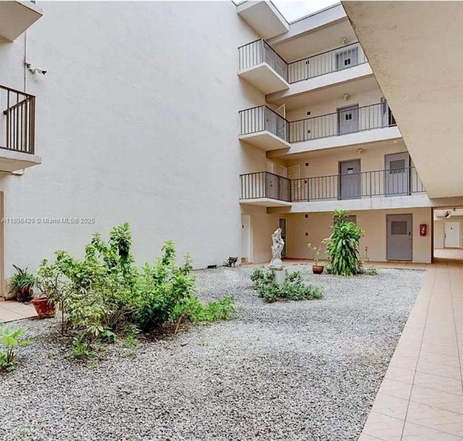 5501 Northwest 7th Street, Unit E408 Miami, FL 33126 - Photo 5 of 27 a front view of a house with garden
