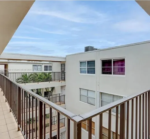 a kitchen with white cabinets and sink