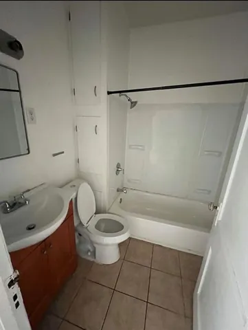 a bathroom with a sink a toilet and bathtub