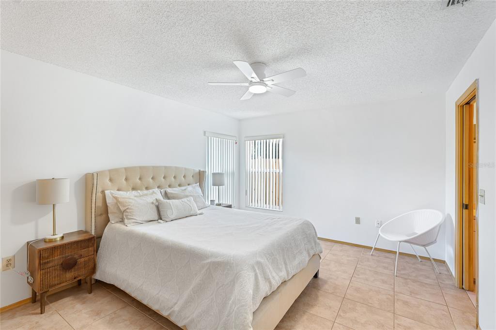 4537 South Lockwood Ridge Road Sarasota, FL 34231 - Photo 10 of 22 a bedroom with a bed and a couch