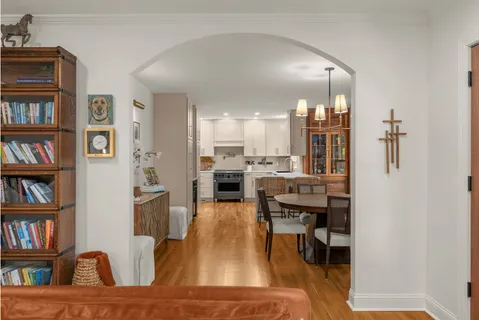 a living room with furniture and a book shelf