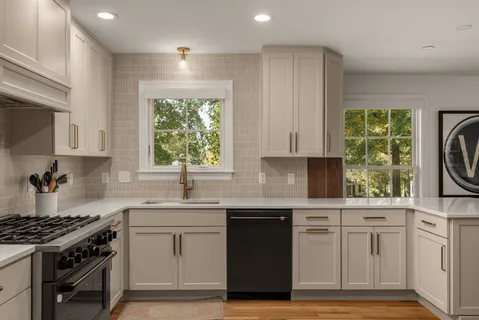 a kitchen with a sink stove and cabinets