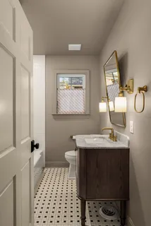 a bathroom with a sink toilet and mirror