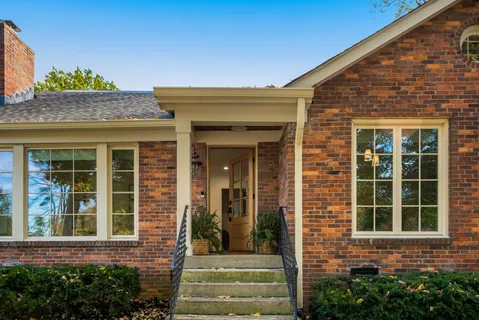 front view of a brick house with a large window