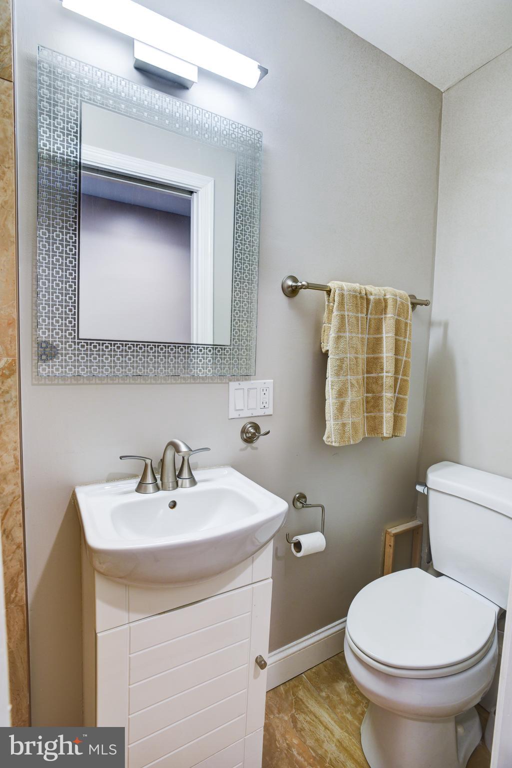 3026 R Street Northwest, Unit 2 Washington, DC 20007 - Photo 20 of 45 a bathroom with a sink a toilet and mirror