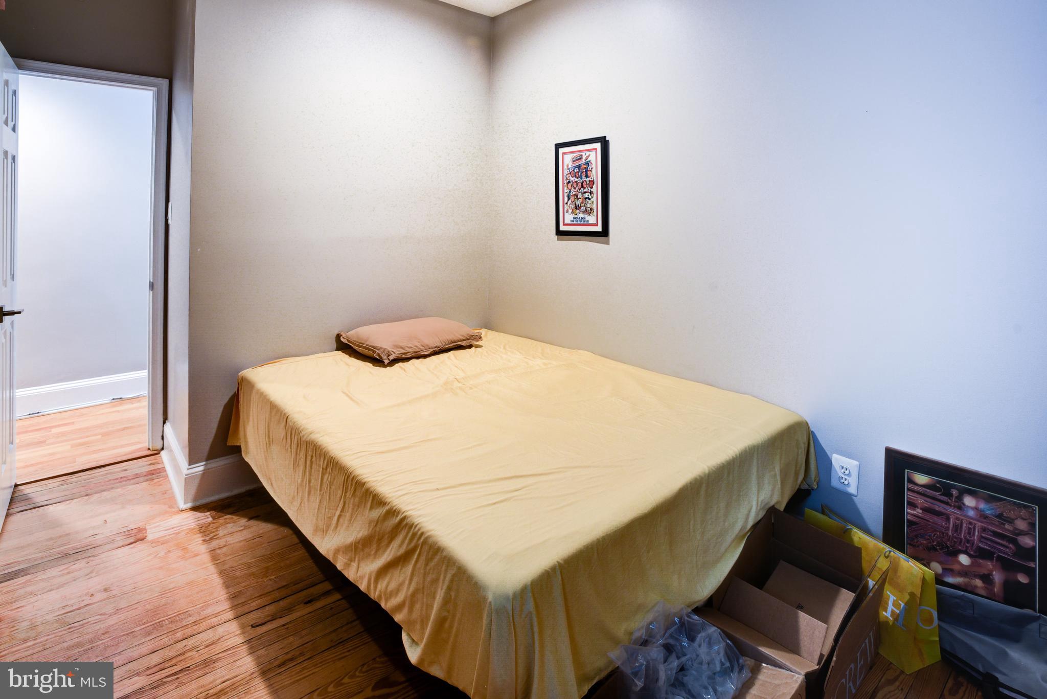 3026 R Street Northwest, Unit 2 Washington, DC 20007 - Photo 23 of 45 a bedroom with a bed and wooden floor