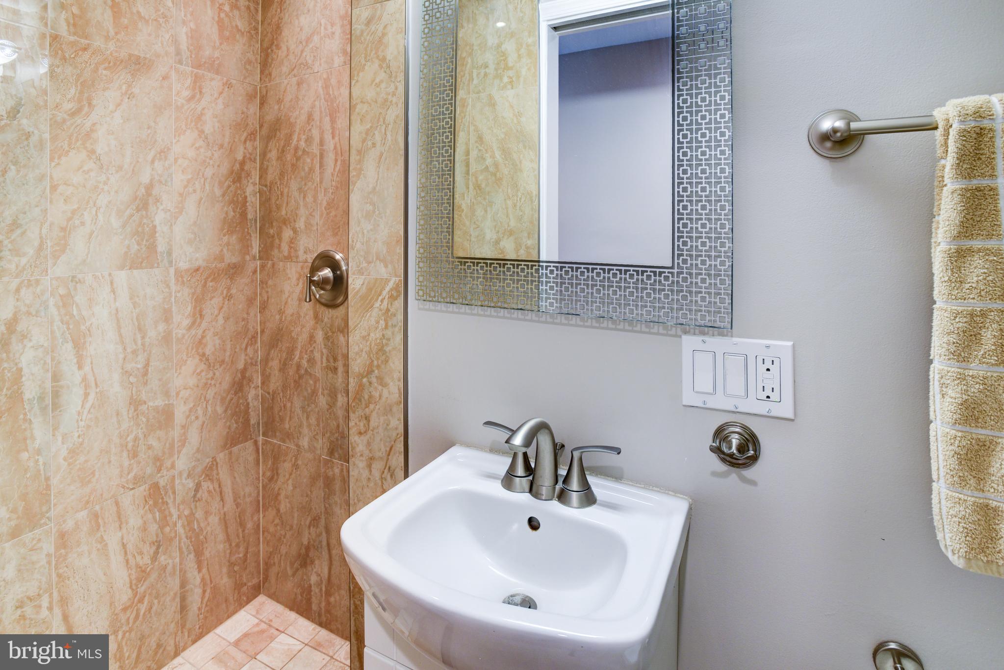 3026 R Street Northwest, Unit 2 Washington, DC 20007 - Photo 25 of 45 a bathroom with a sink and a mirror