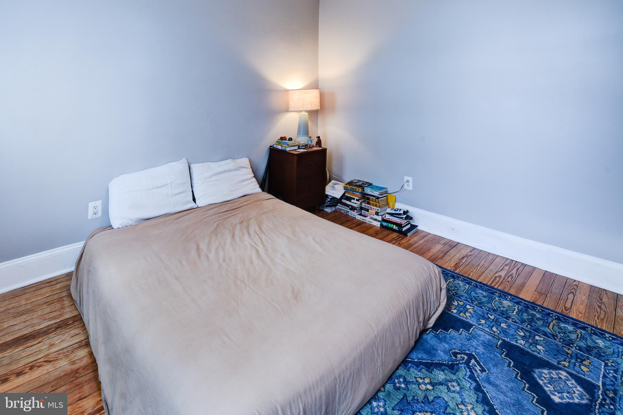 3026 R Street Northwest, Unit 2 Washington, DC 20007 - Photo 29 of 45 a bedroom with a bed and a lamp