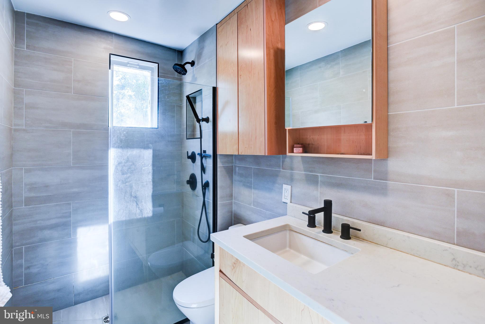3026 R Street Northwest, Unit 2 Washington, DC 20007 - Photo 33 of 45 a bathroom with a sink toilet and shower