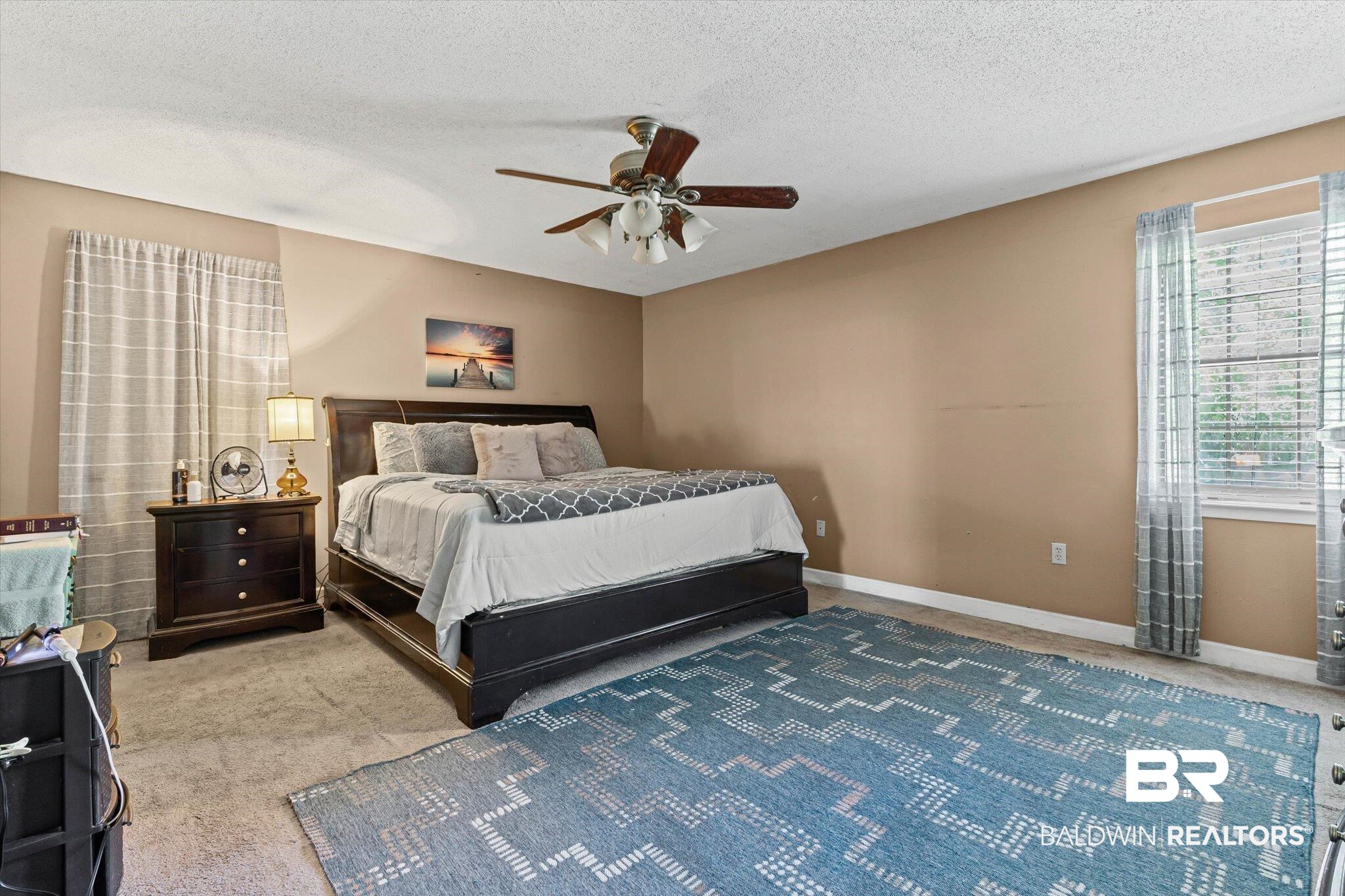 11440 Diffee Road Grand Bay, AL 36541 - Photo 12 of 22 Carpeted bedroom featuring ceiling fan and a textured ceiling