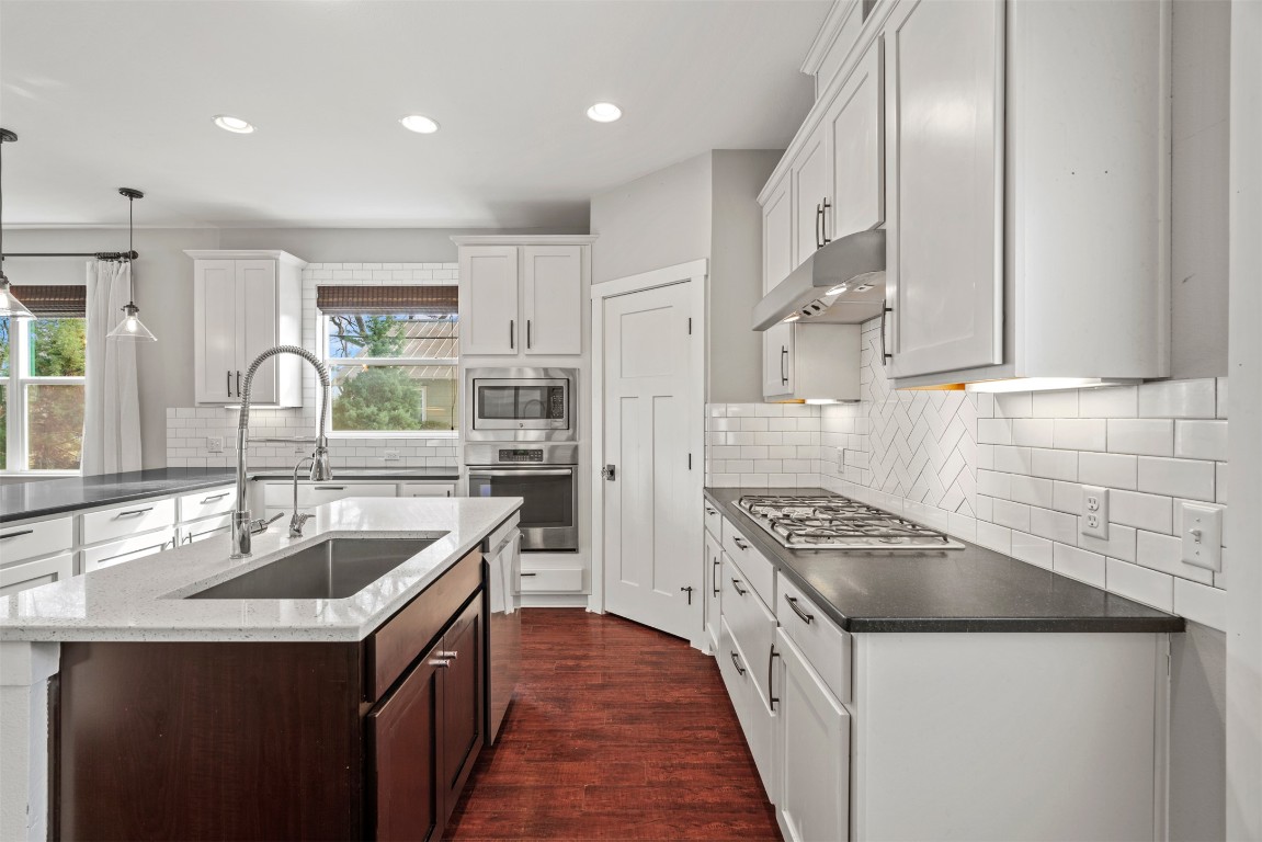 1912 South Church Street Georgetown, TX 78626 - Photo 11 of 40 a kitchen that has a sink a stove and chairs