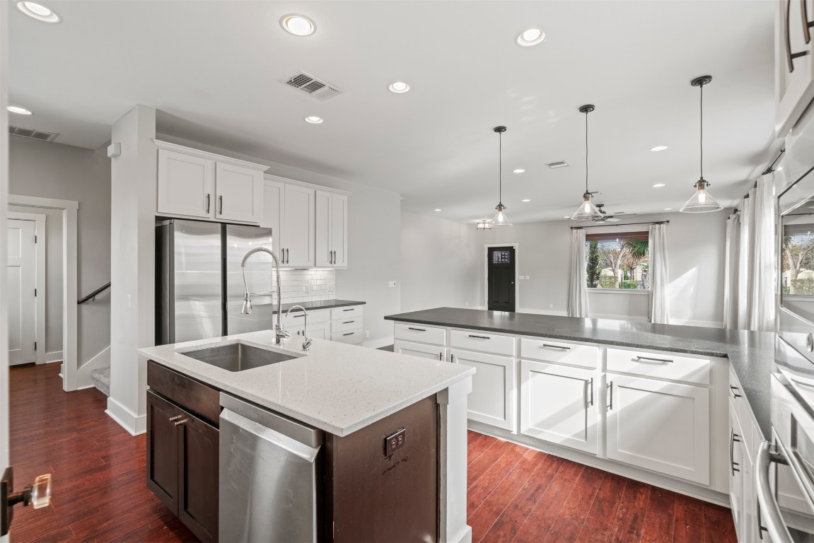 1912 South Church Street Georgetown, TX 78626 - Photo 14 of 40 a kitchen with a sink a center island stainless steel appliances and cabinets