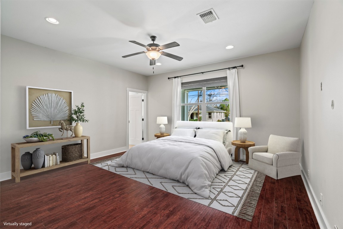 1912 South Church Street Georgetown, TX 78626 - Photo 16 of 40 a bedroom with a large bed and a chandelier