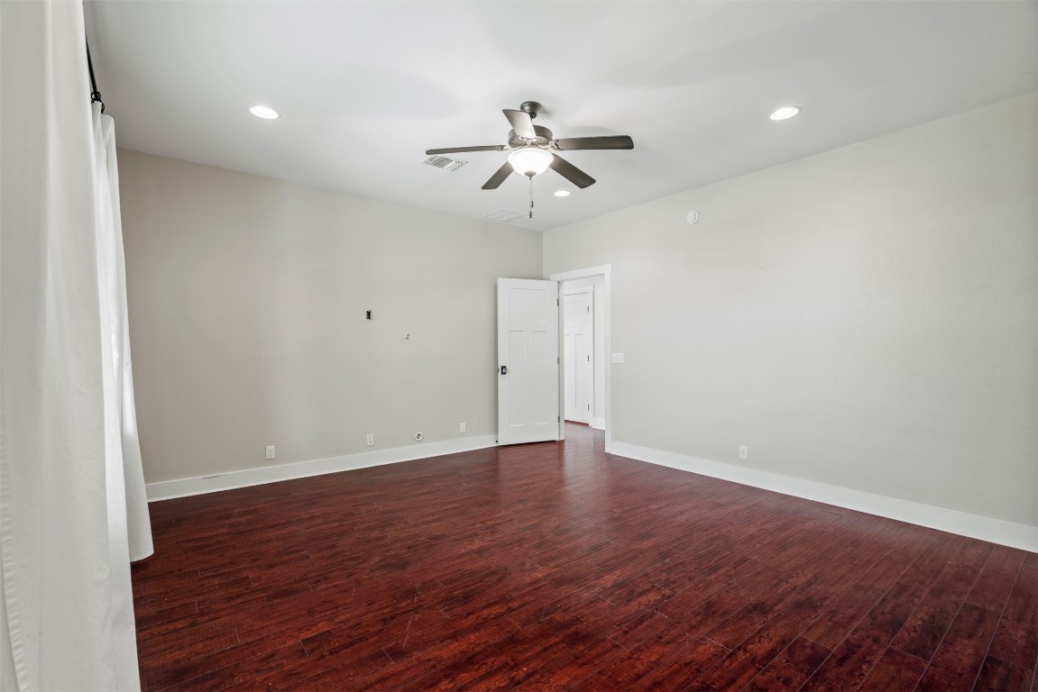 1912 South Church Street Georgetown, TX 78626 - Photo 18 of 40 an empty room with wooden floor ceiling fan and window