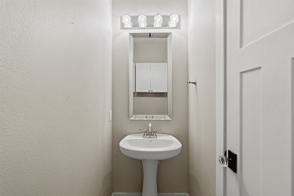 1912 South Church Street Georgetown, TX 78626 - Photo 25 of 40 a bathroom with a sink and a mirror