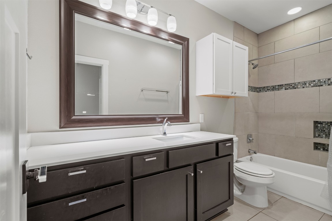 1912 South Church Street Georgetown, TX 78626 - Photo 37 of 40 a bathroom with a granite countertop toilet sink and mirror