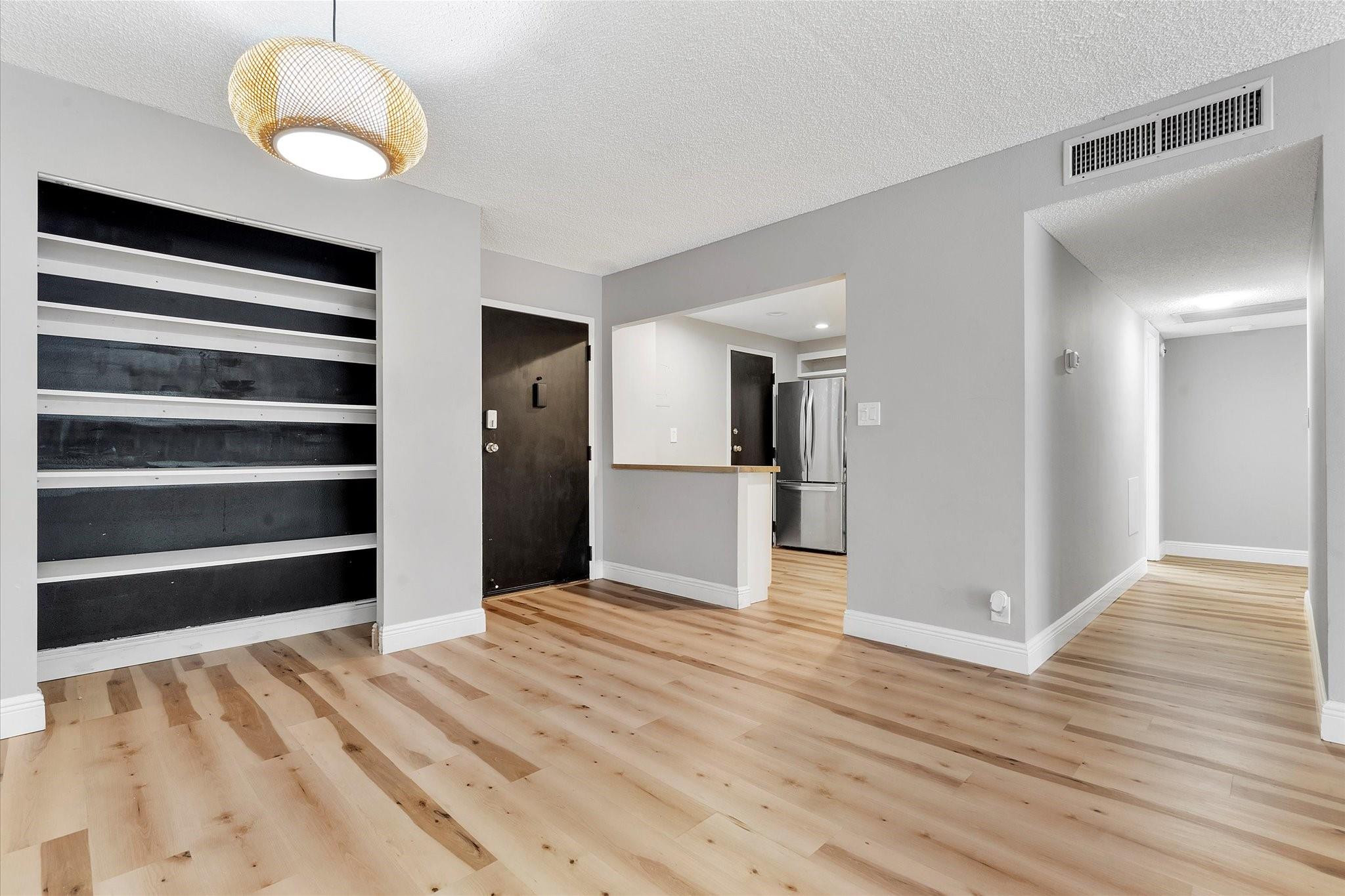 a view of a bedroom with wooden floor and bathroom