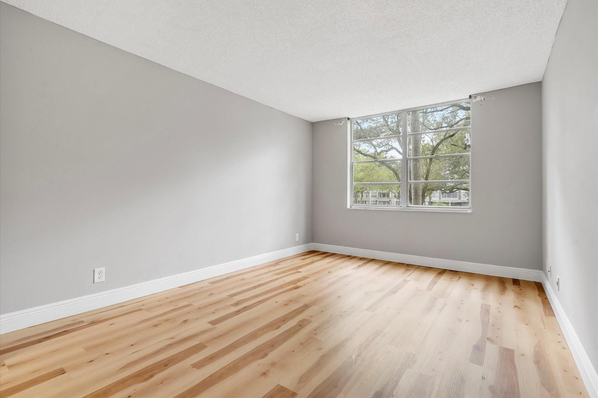 6500 Cypress Road, Unit 211 Plantation, FL 33317 - Photo 21 of 40 an empty room with wooden floor and windows