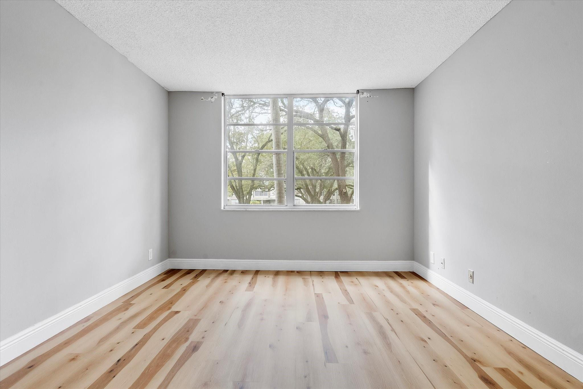 6500 Cypress Road, Unit 211 Plantation, FL 33317 - Photo 28 of 40 an empty room with wooden floor and windows