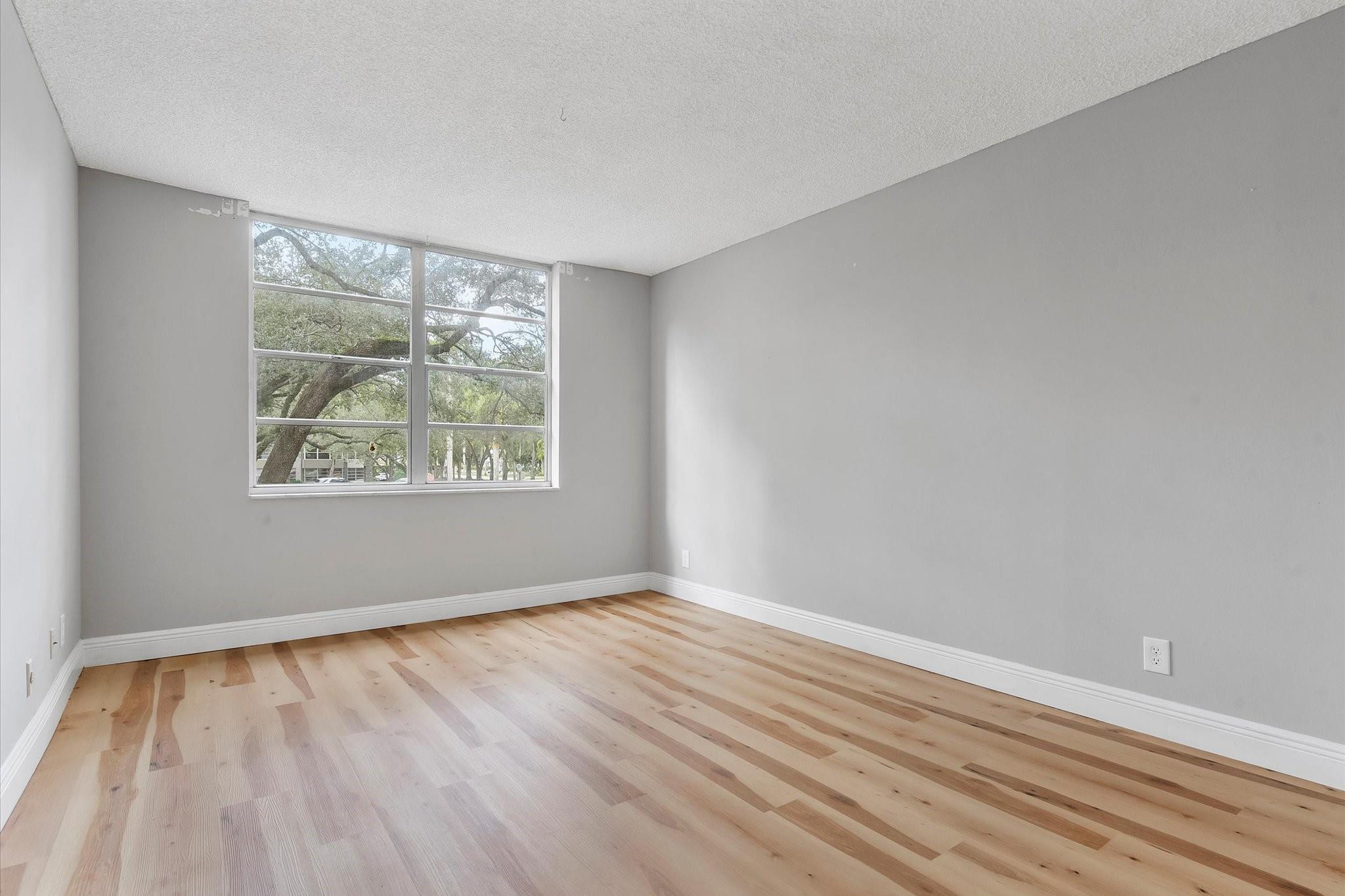 6500 Cypress Road, Unit 211 Plantation, FL 33317 - Photo 29 of 40 an empty room with wooden floor and windows