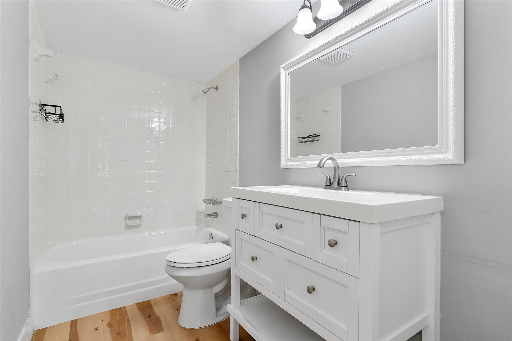 6500 Cypress Road, Unit 211 Plantation, FL 33317 - Photo 33 of 40 a bathroom with a double vanity sink toilet mirror and bathtub