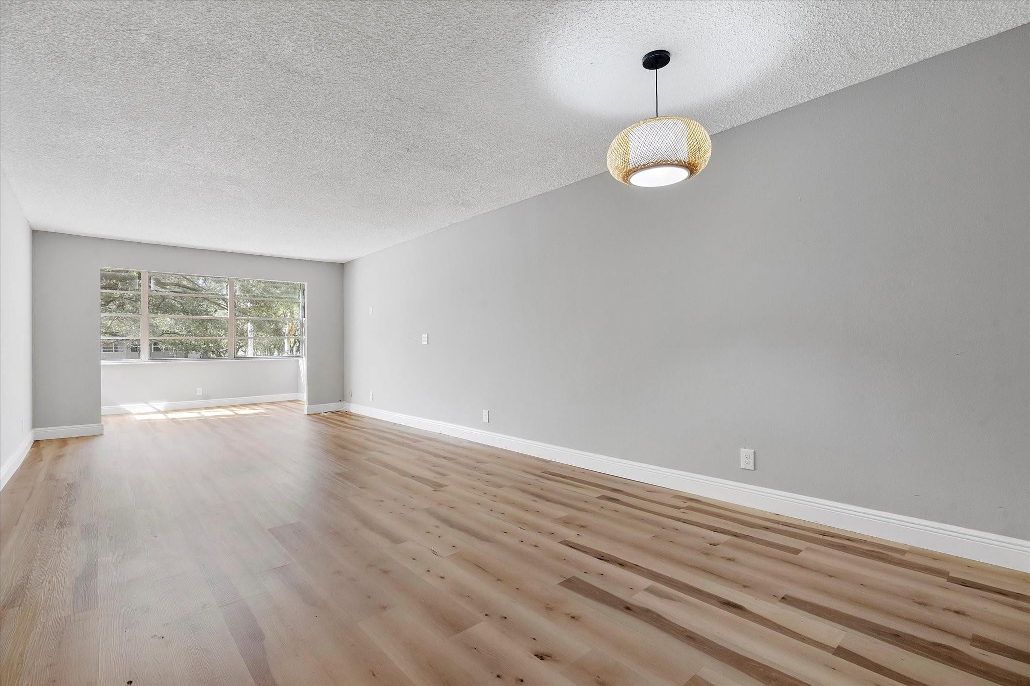 6500 Cypress Road, Unit 211 Plantation, FL 33317 - Photo 4 of 40 an empty room with wooden floor and windows