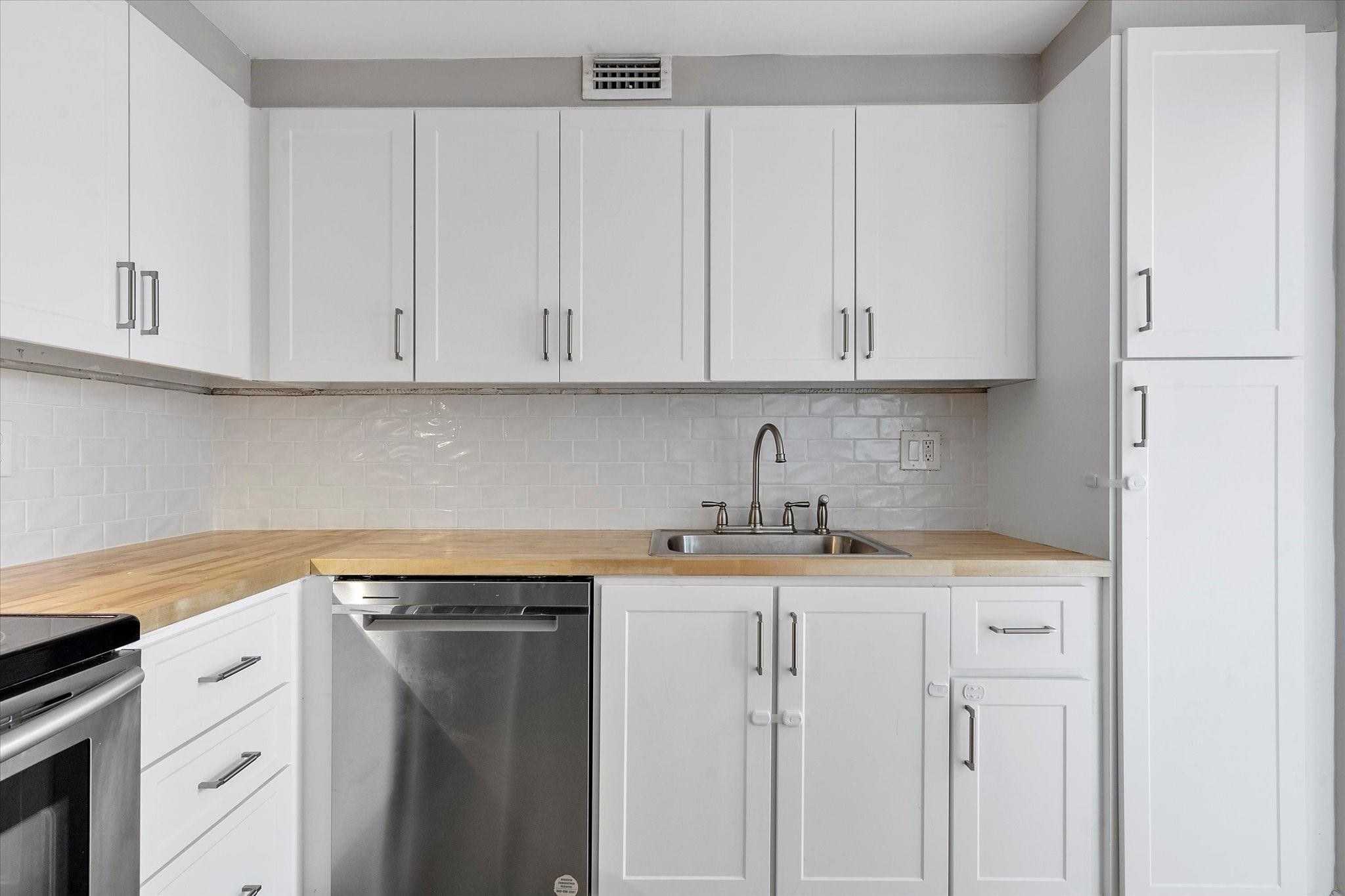 6500 Cypress Road, Unit 211 Plantation, FL 33317 - Photo 7 of 40 a kitchen with stainless steel appliances granite countertop a sink and dishwasher with white cabinets