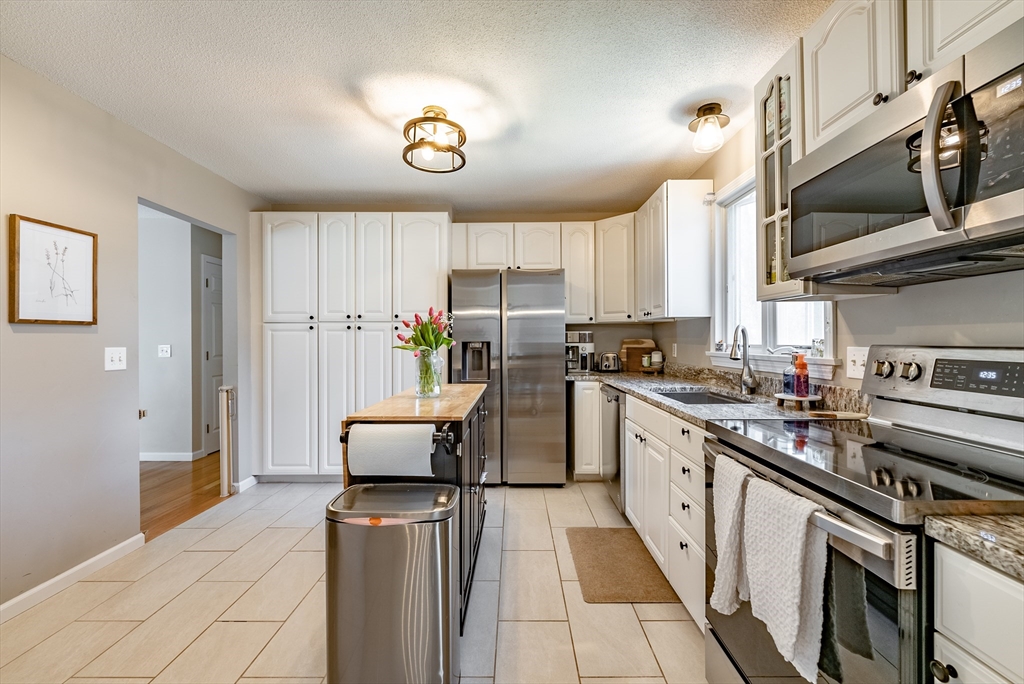 5 Corning Street Springfield, MA 01108 - Photo 13 of 29 a kitchen with stainless steel appliances granite countertop a stove a sink and a refrigerator