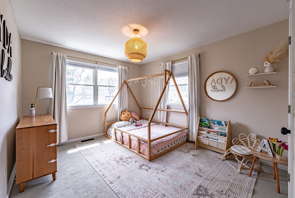 5 Corning Street Springfield, MA 01108 - Photo 20 of 29 a bedroom with a bed a clock and a table in it