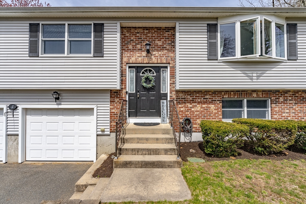 5 Corning Street Springfield, MA 01108 - Photo 2 of 29 a front view of a house with a yard and garage