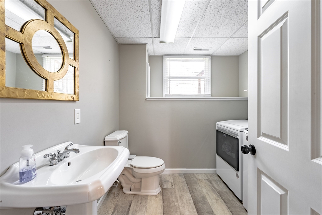 5 Corning Street Springfield, MA 01108 - Photo 25 of 29 a bathroom with a sink a toilet and a mirror
