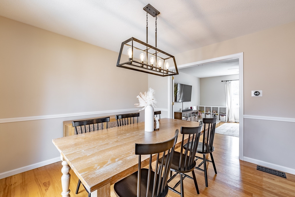 5 Corning Street Springfield, MA 01108 - Photo 8 of 29 a view of a dining room with furniture a chandelier and wooden floor