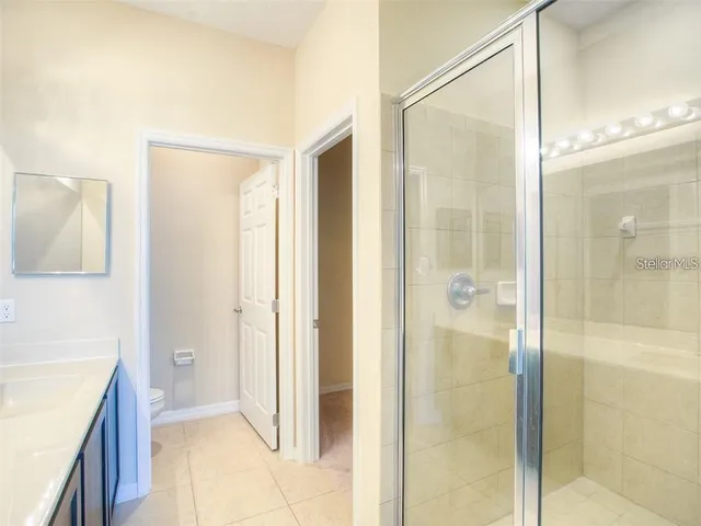 a bathroom with a shower and a sink