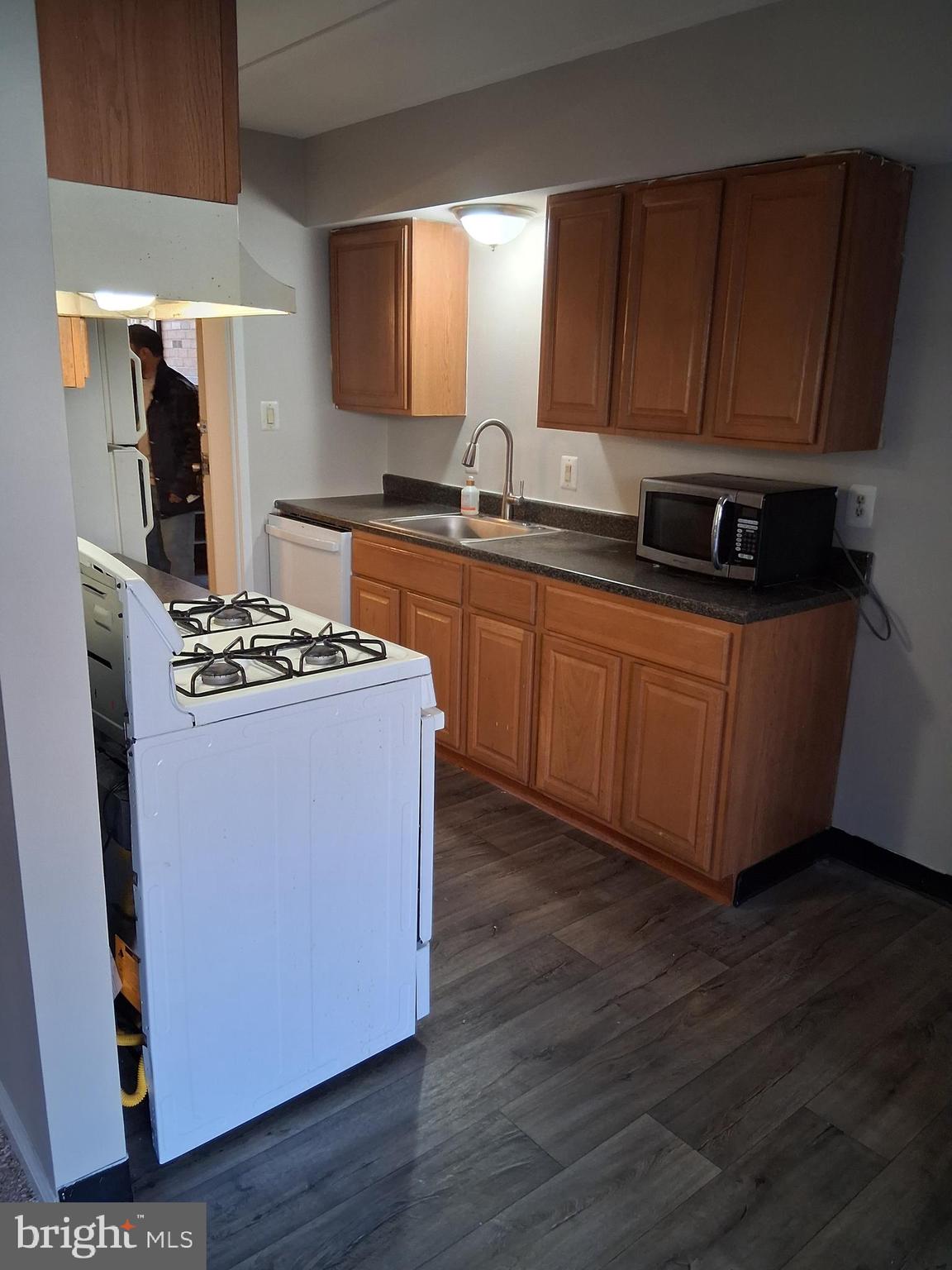 2305 Freetown Court, Unit 2B Reston, VA 20191 - Photo 3 of 15 a kitchen with stainless steel appliances granite countertop a stove a sink and a refrigerator