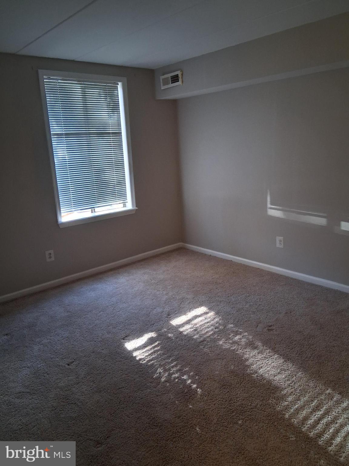 2305 Freetown Court, Unit 2B Reston, VA 20191 - Photo 6 of 15 an empty room with windows