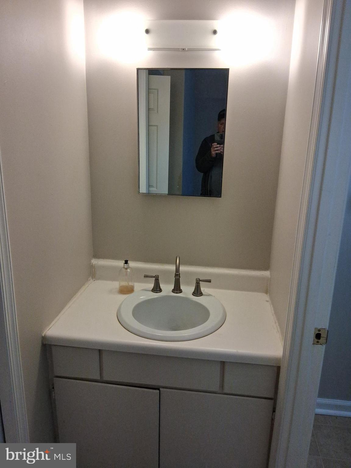 2305 Freetown Court, Unit 2B Reston, VA 20191 - Photo 9 of 15 a bathroom with a sink and a mirror