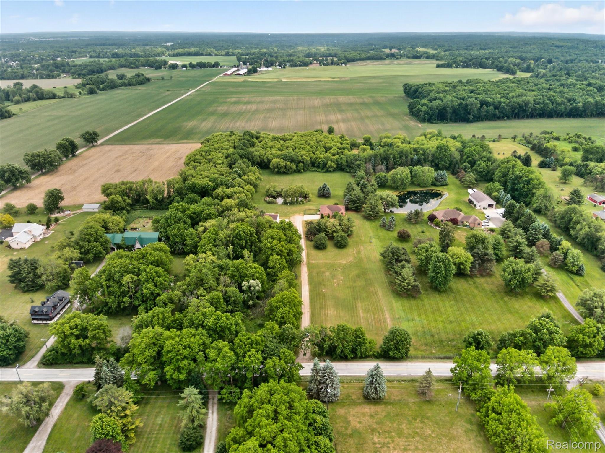 8558 37 Mile Road Romeo, MI 48065 - Photo 24 of 29 Expansive property featuring mature trees, open green spaces, and a private pond