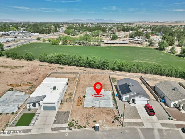 an aerial view of residential houses with outdoor space