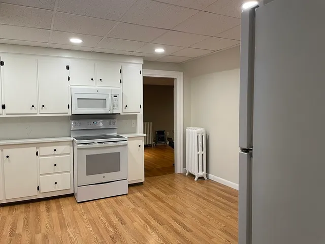 a kitchen with stainless steel appliances a refrigerator and a stove top oven