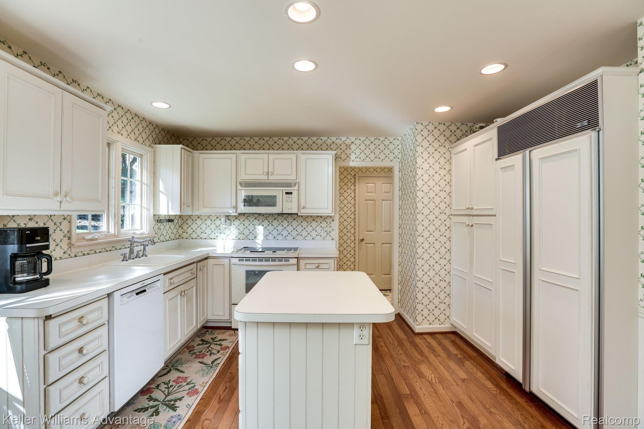 888 Hemlock Court Rochester, MI 48307 - Photo 5 of 32 White kitchen with beautiful natural, hardwood floors