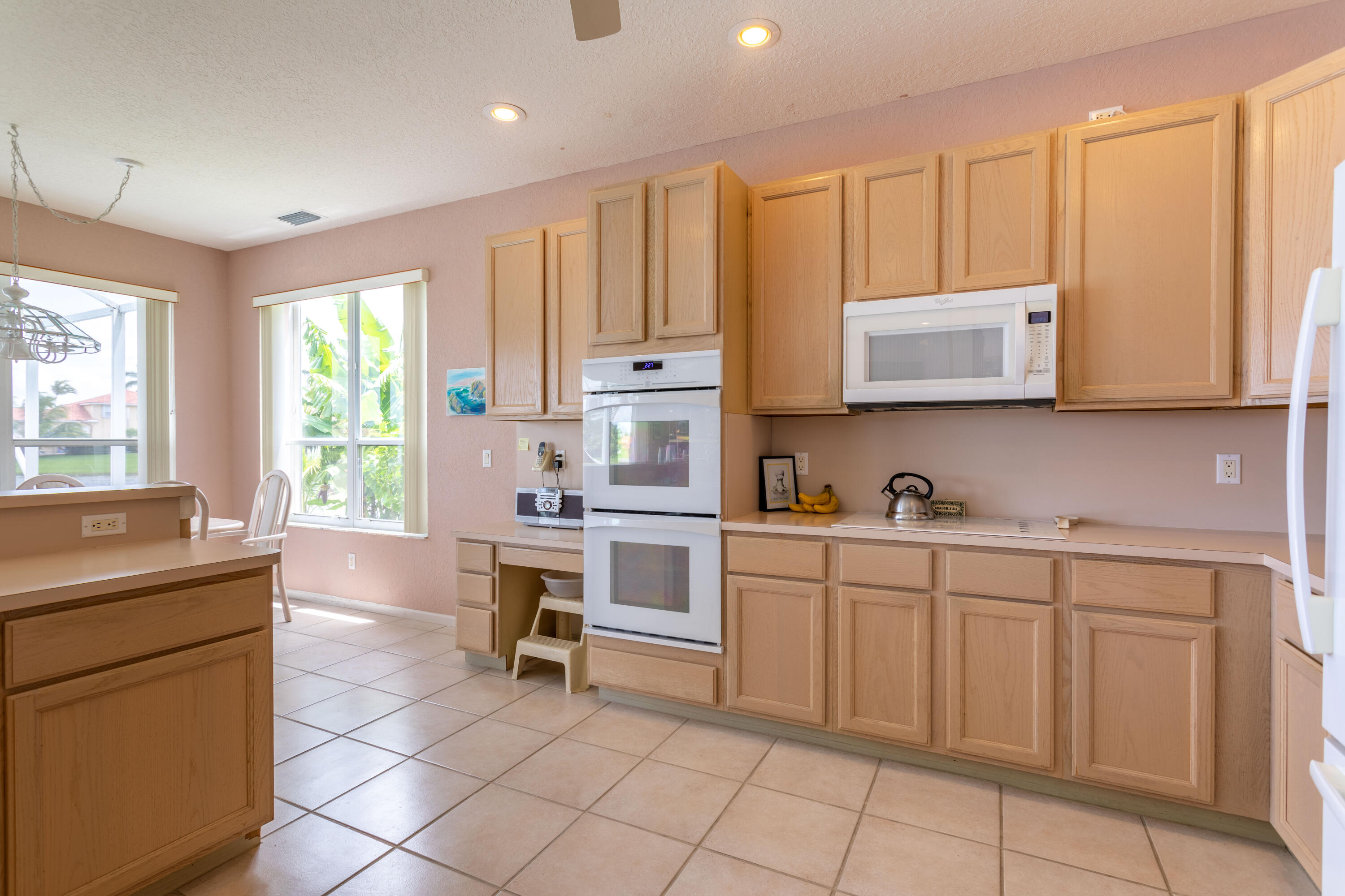 12601 Maypan Drive Boca Raton, FL 33428 - Photo 12 of 46 a kitchen with appliances cabinets and a sink
