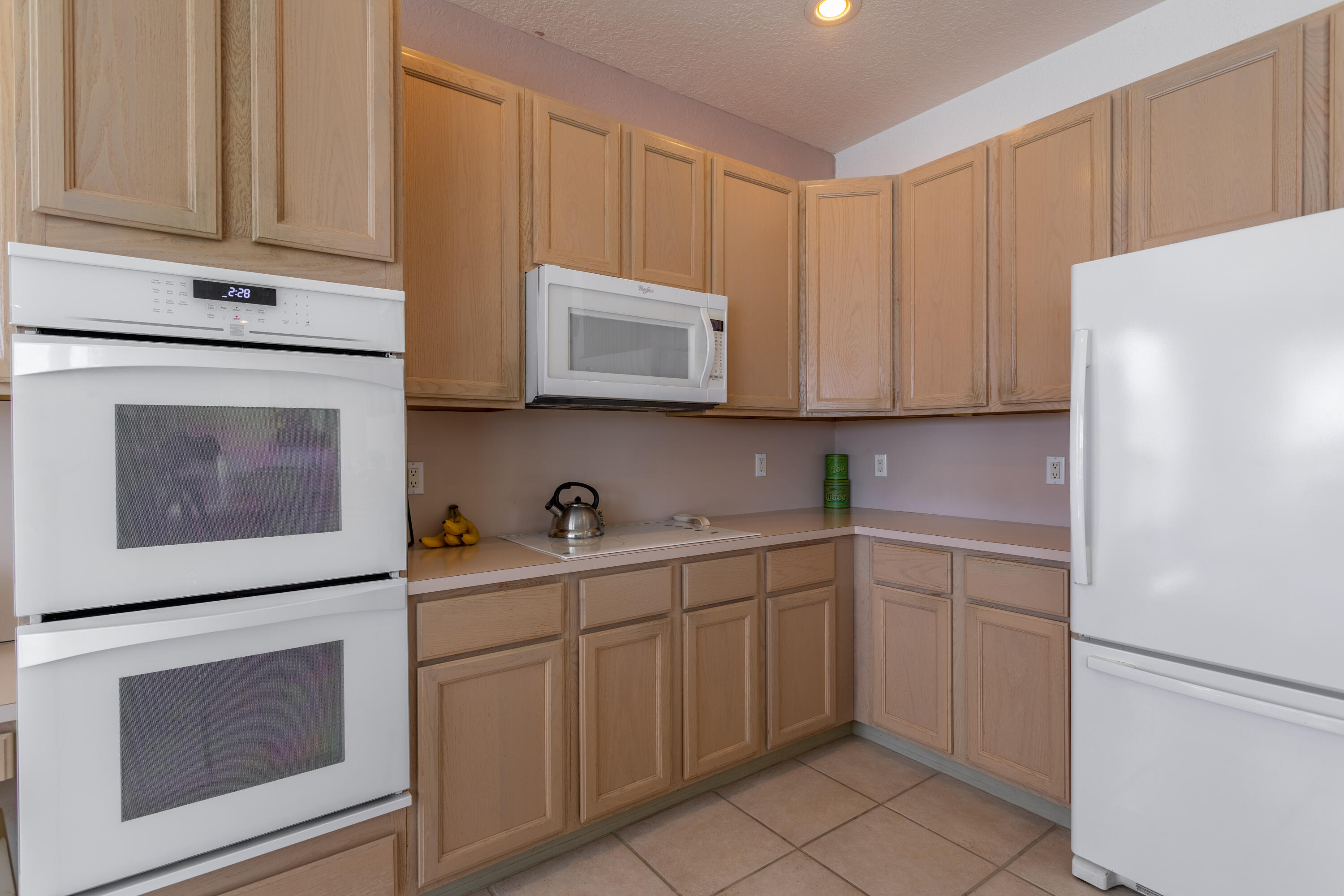 12601 Maypan Drive Boca Raton, FL 33428 - Photo 13 of 46 a kitchen with stainless steel appliances granite countertop white cabinets and stove top oven
