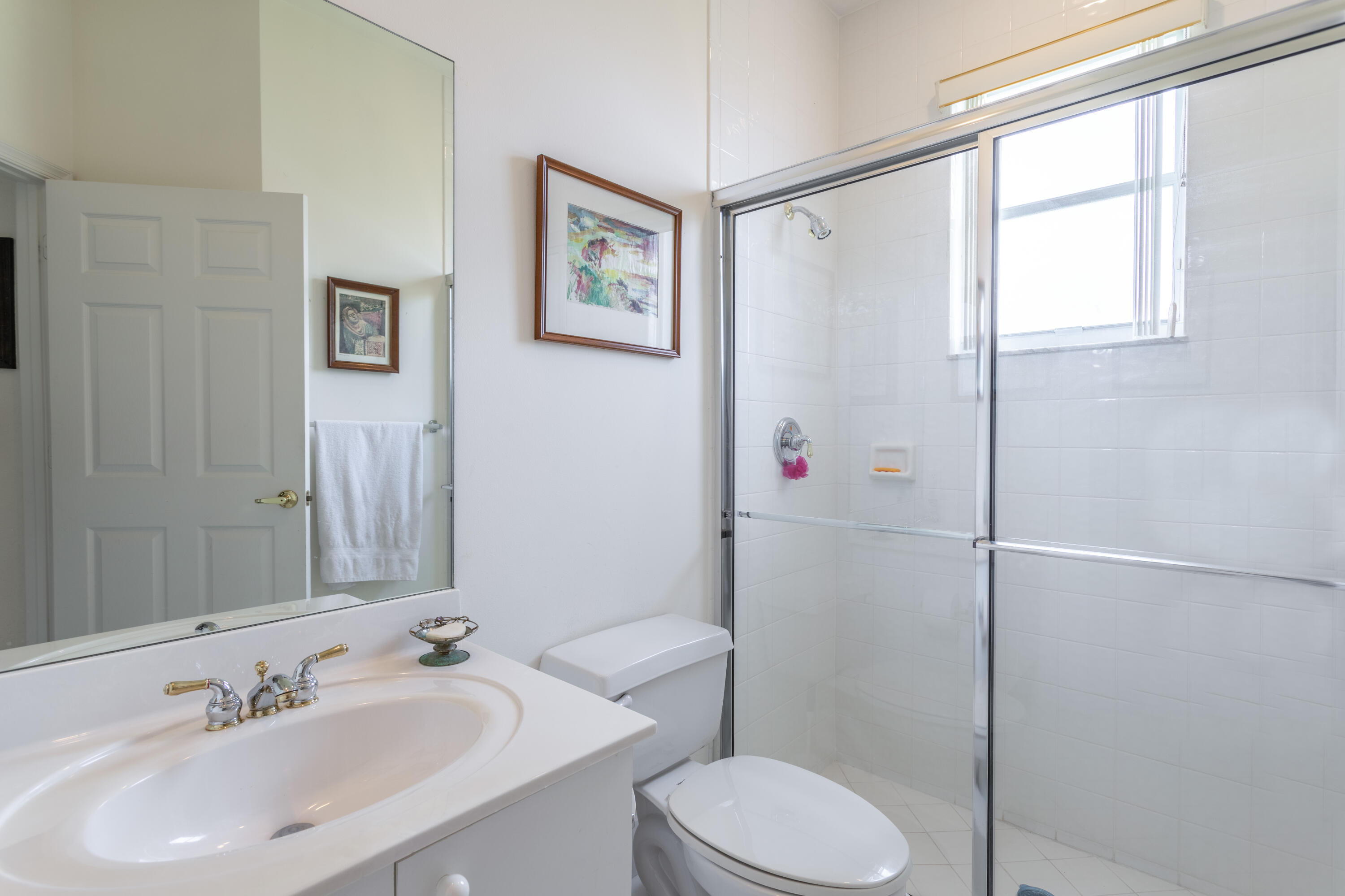 12601 Maypan Drive Boca Raton, FL 33428 - Photo 14 of 46 a bathroom with a sink toilet and shower